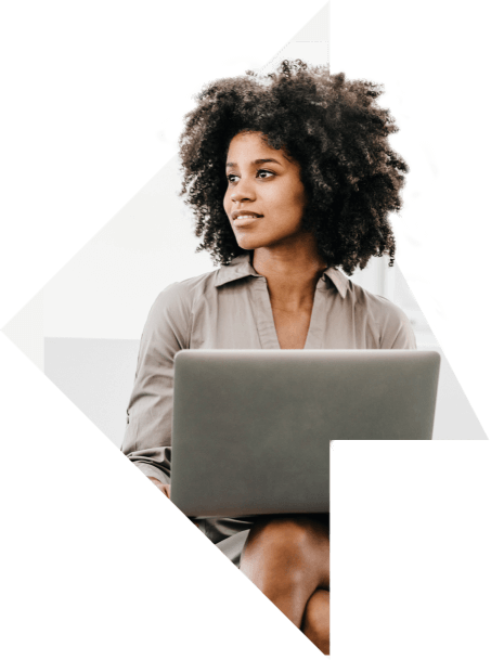 Woman sitting with her laptop in an office setting.